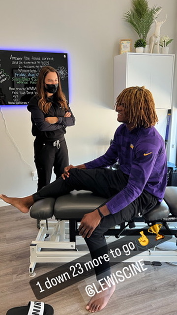 Dr. Heather talking with a patient seated on the treatment table