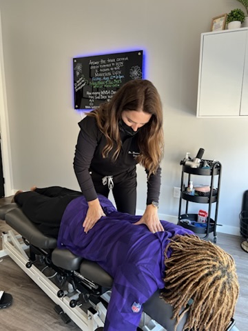 Dr. Heather providing soft-tissue work on a patient’s back at Excelsior & Grand Chiropractic in St. Louis Park, MN
