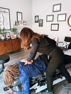 Dr. Heather Flatgard, Certified Chiropractic Sports Physician, treating an athlete