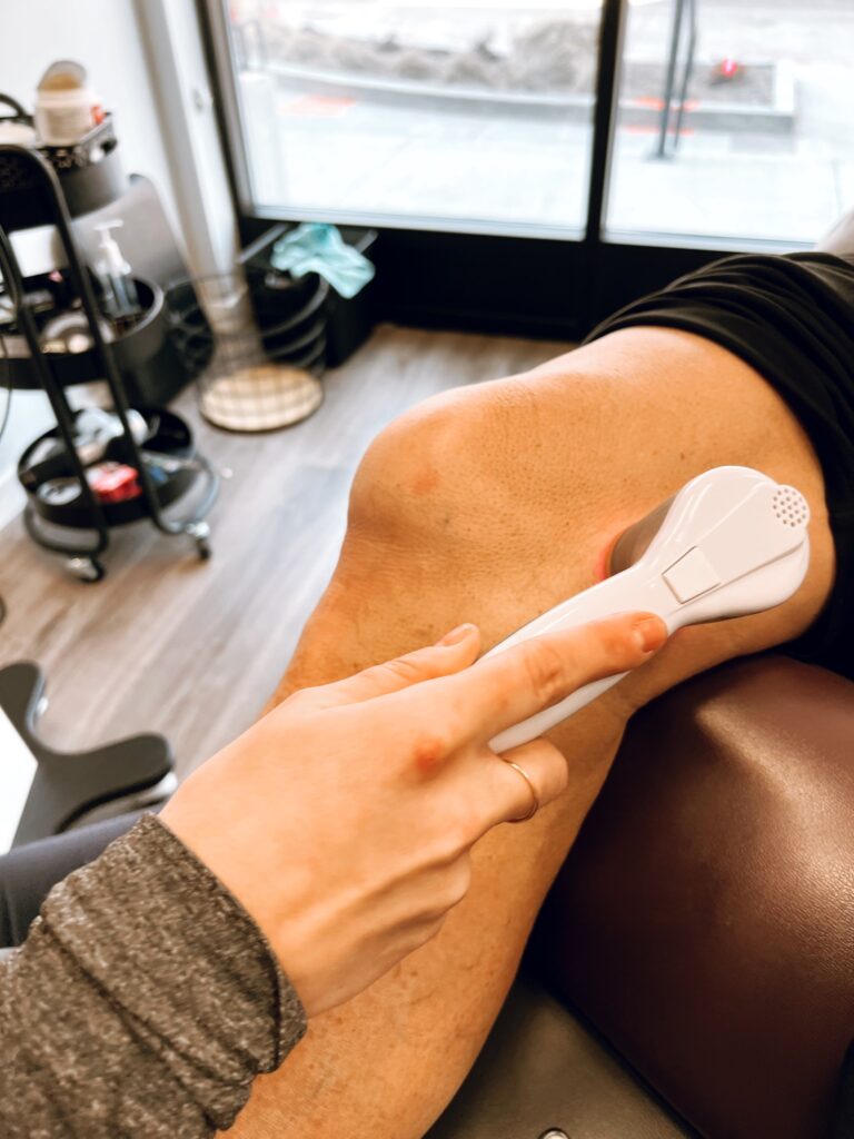 Class 4 laser therapy on a patient’s knee at Excelsior & Grand Chiropractic in St. Louis Park, MN