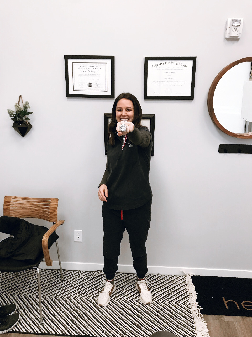 Dr. Heather, Army National Guard veteran and chiropractor, in the treatment room at Excelsior & Grand Chiropractic