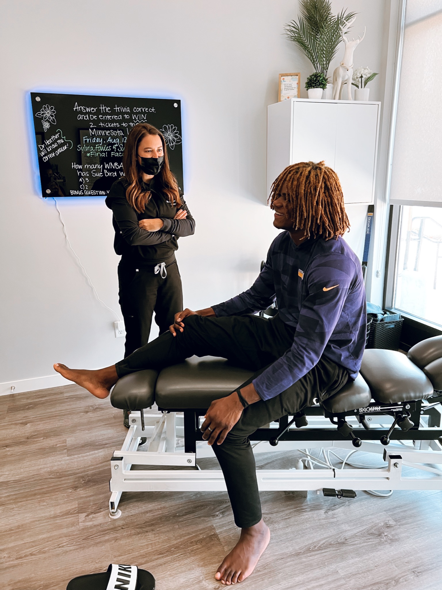 Dr. Heather talking with a patient about chiropractic care at Excelsior & Grand Chiropractic in St. Louis Park, MN
