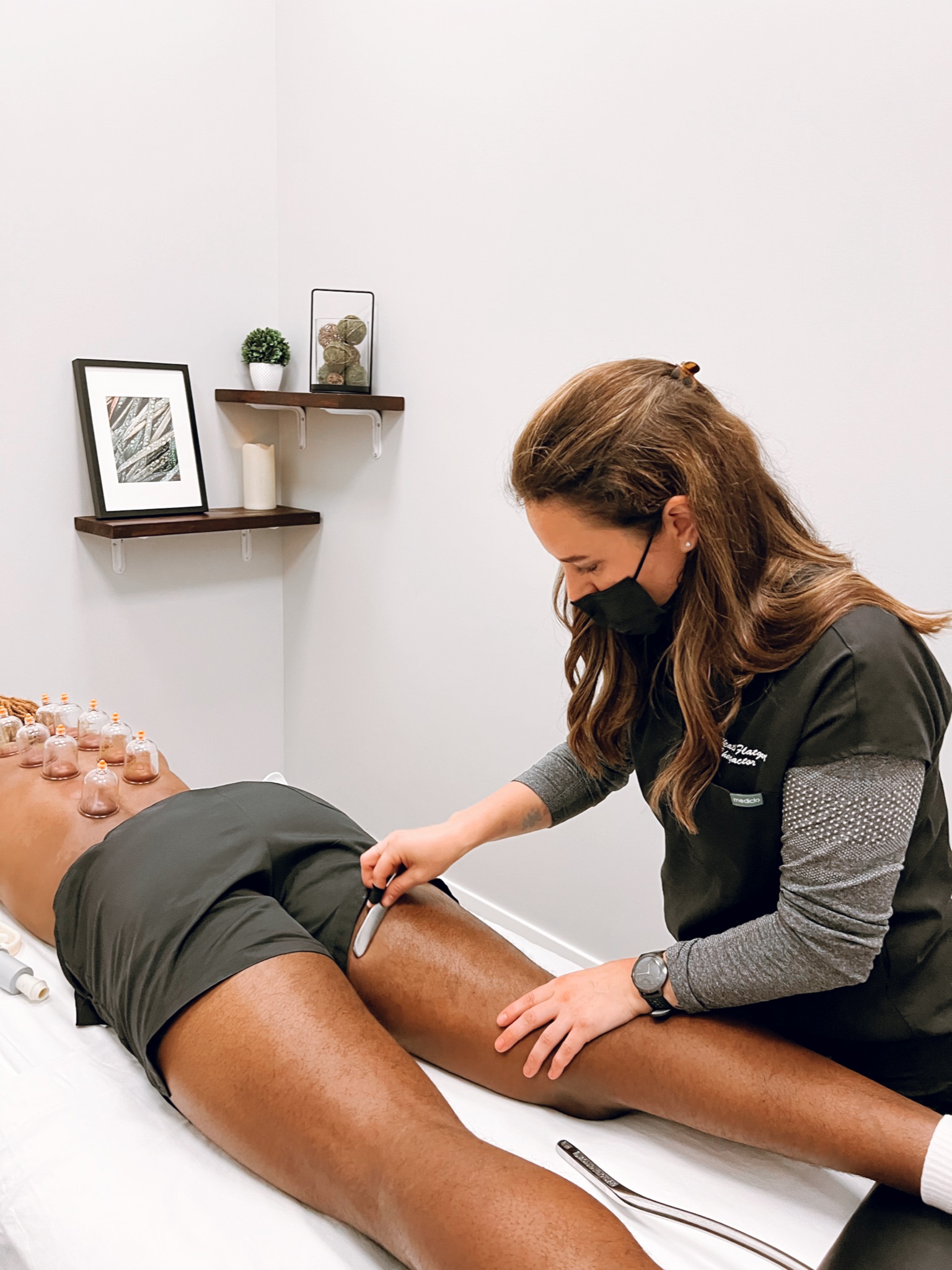 Dr. Heather providing soft-tissue treatment on a patient’s hamstring