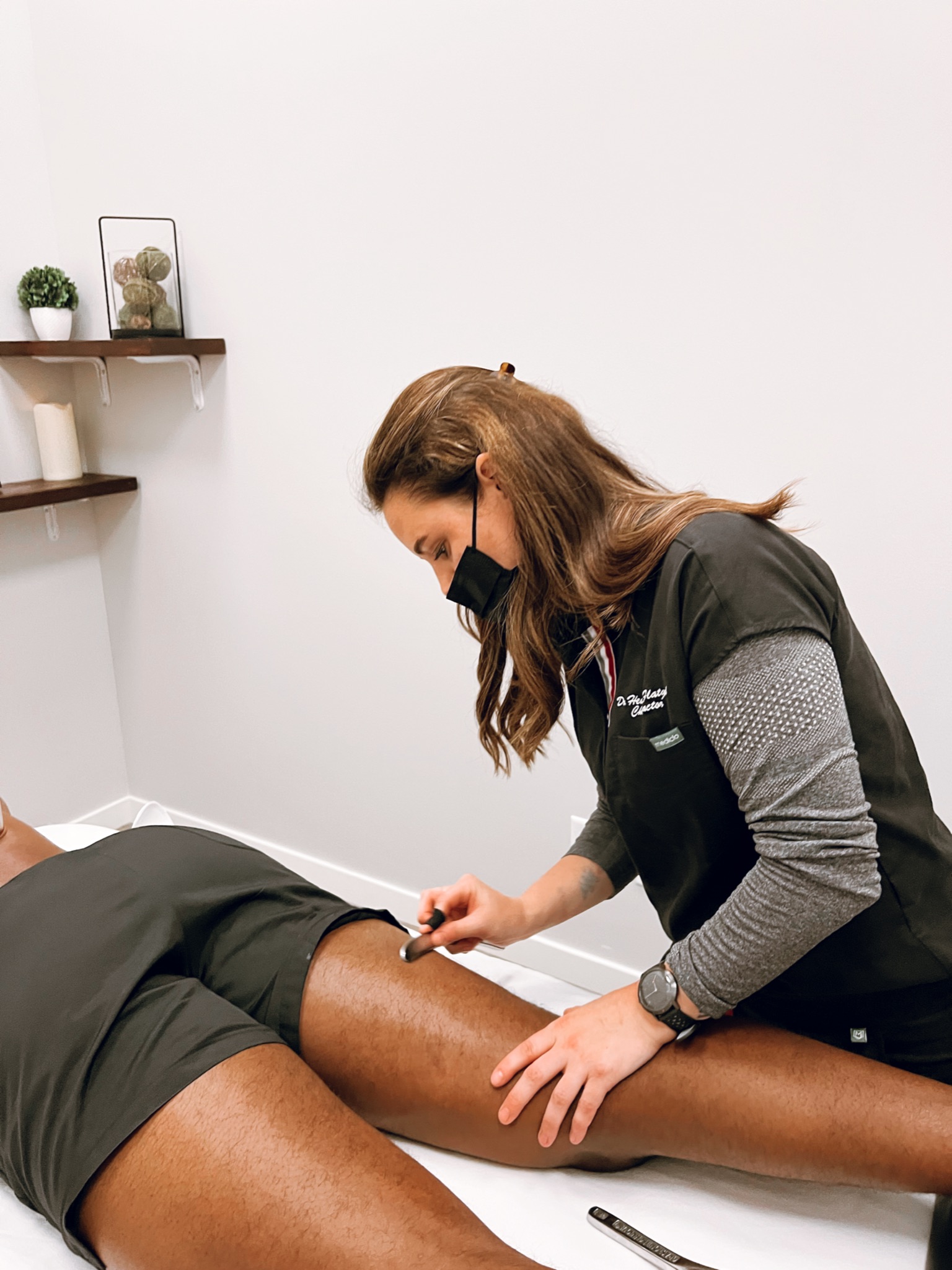 Dr. Heather providing Graston Technique on a patient’s leg