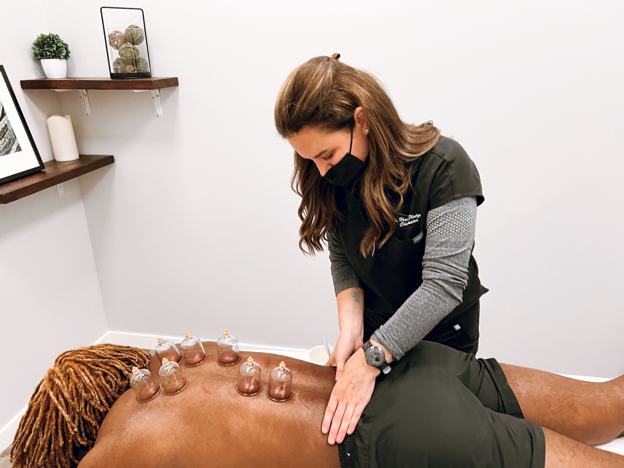 Dr. Heather providing soft-tissue treatment with cupping during chiropractic care in St. Louis Park, MN