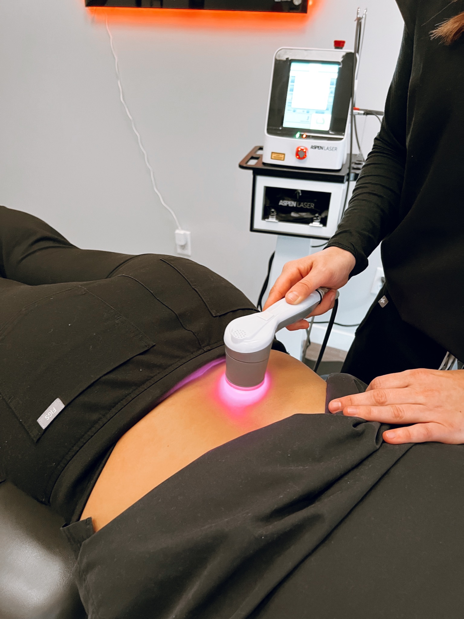 Class 4 laser therapy on a patient’s low back at Excelsior & Grand Chiropractic